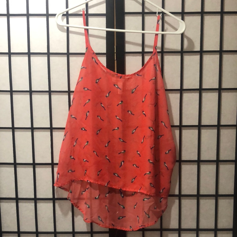 A semi sheer coral hummingbird tank top